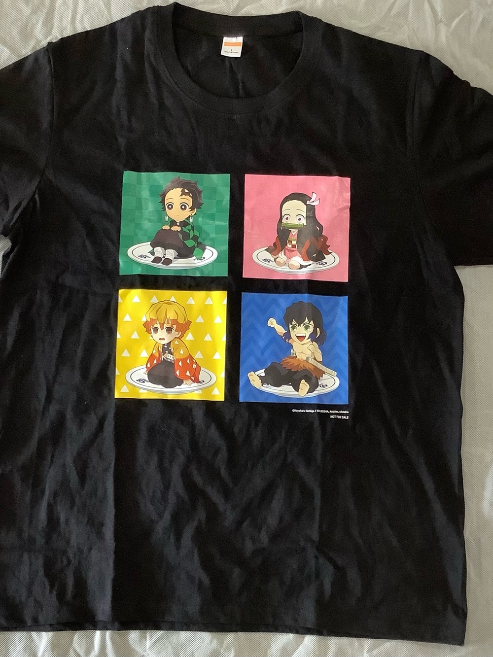 Black Demon Slayer T-shirt with four chibi characters on plates